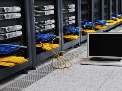 modern aluminium thin laptop computer at server network room representing concept of control and remote access and support